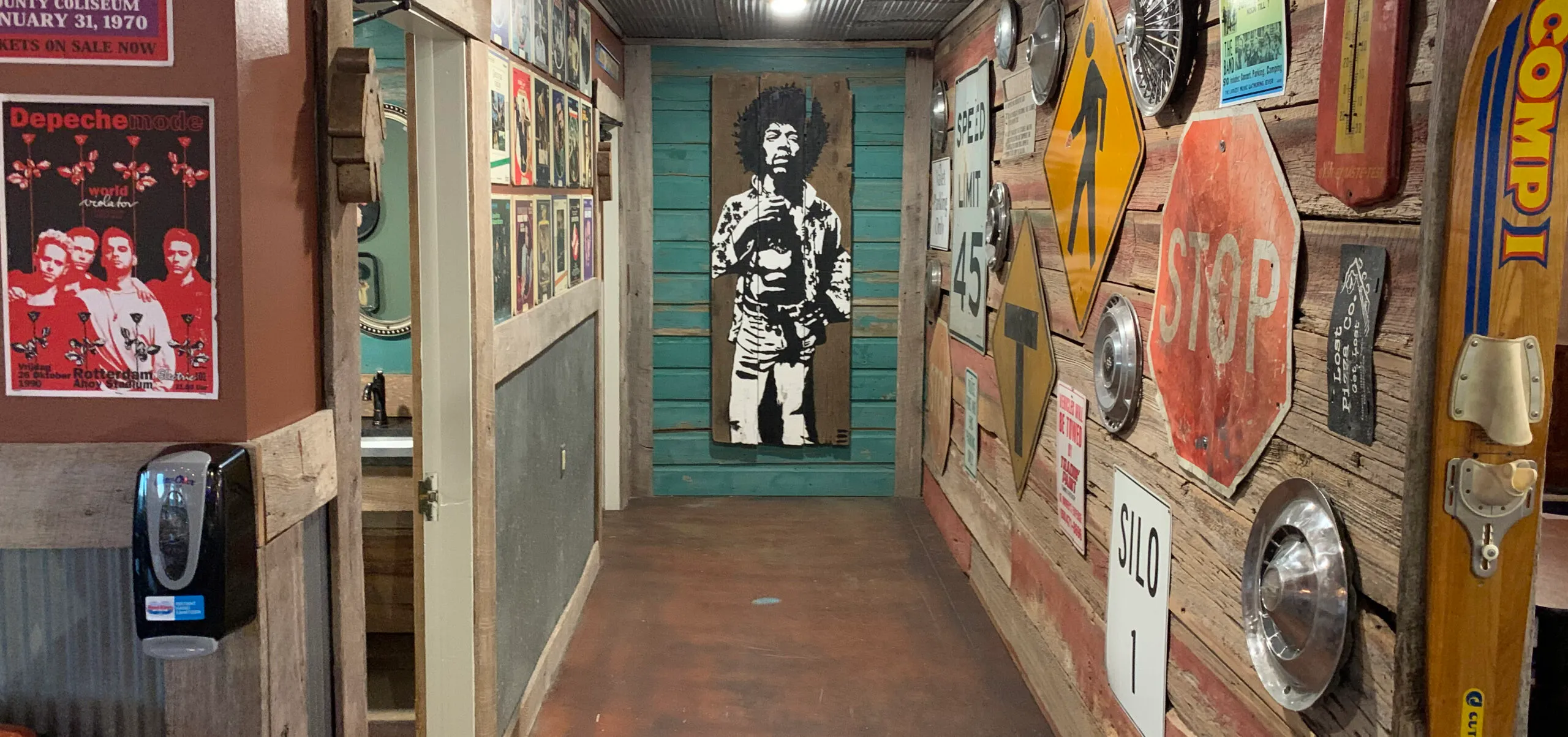 Vintage signs and music artwork inside Lost Pizza Co. in Benton